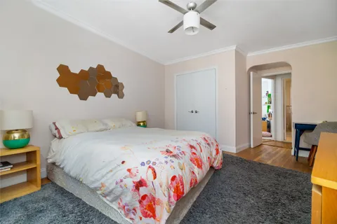 a bedroom with a bed and a chandelier