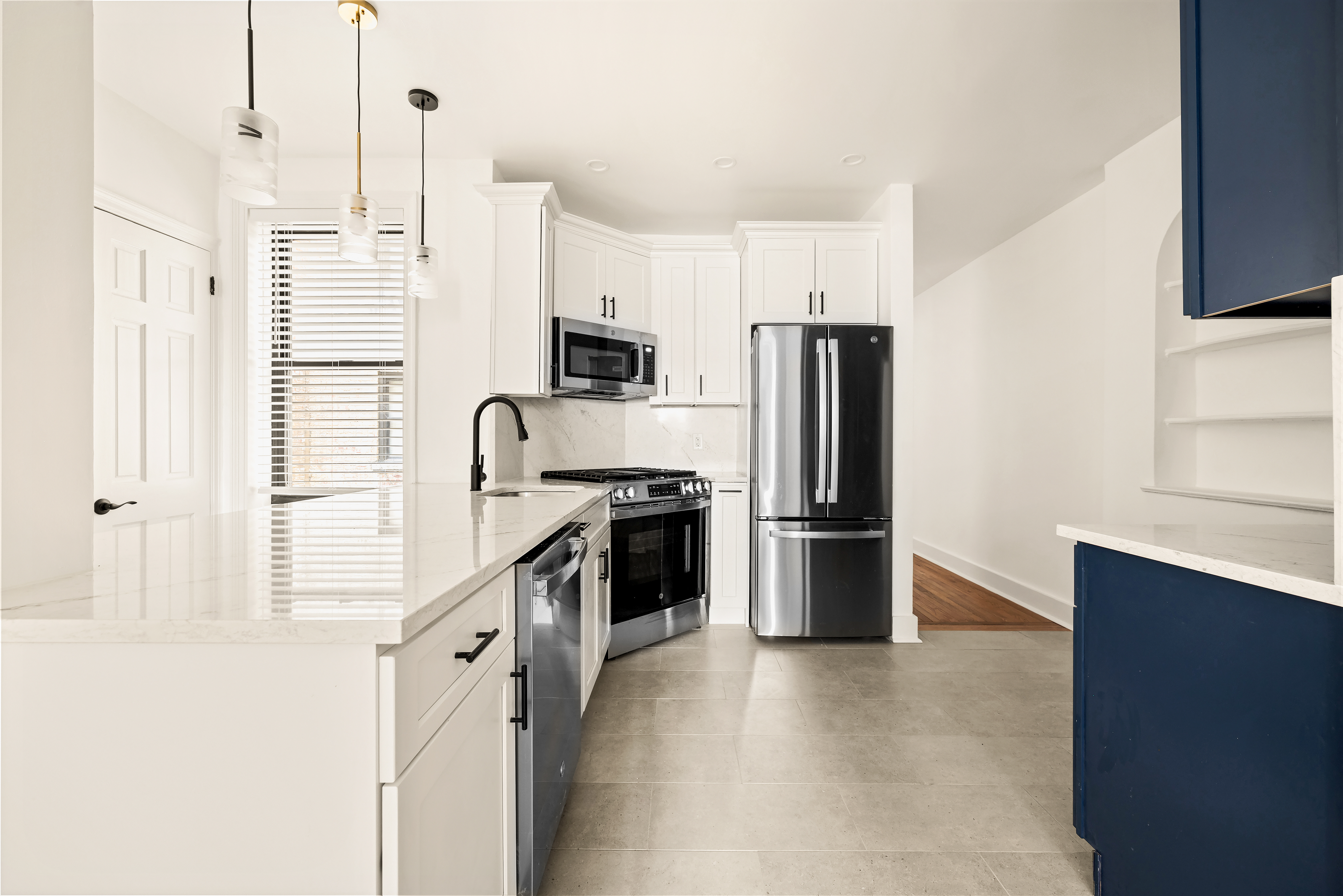 a kitchen with a refrigerator a stove and a sink