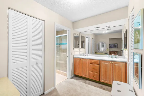 a large bathroom with a double vanity sink and mirror