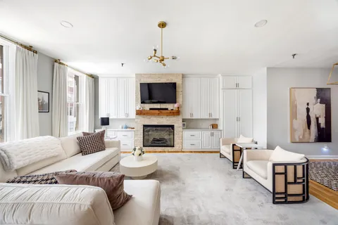 a spacious bedroom with a bed and a fireplace