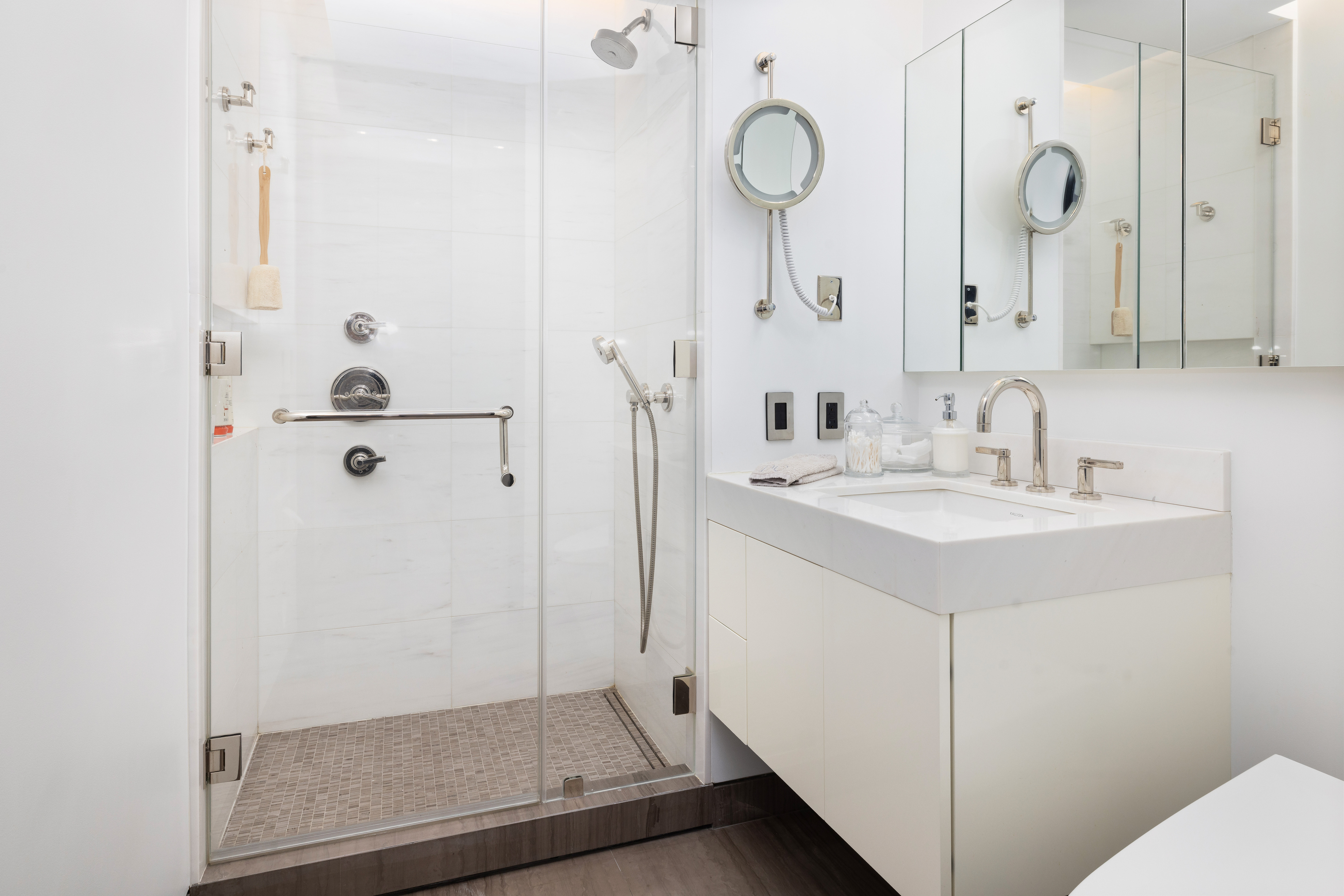 279 Central Park West, Unit 8BC Manhattan, NY 10024 - Photo 11 of 20 a bathroom with a sink a mirror a shower and vanity
