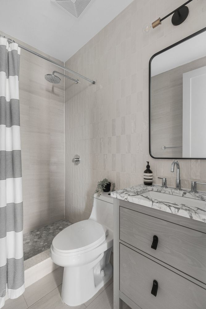 249 Hull Street, Unit C Brooklyn, NY 11233 - Photo 11 of 14 a bathroom with a sink a toilet and shower