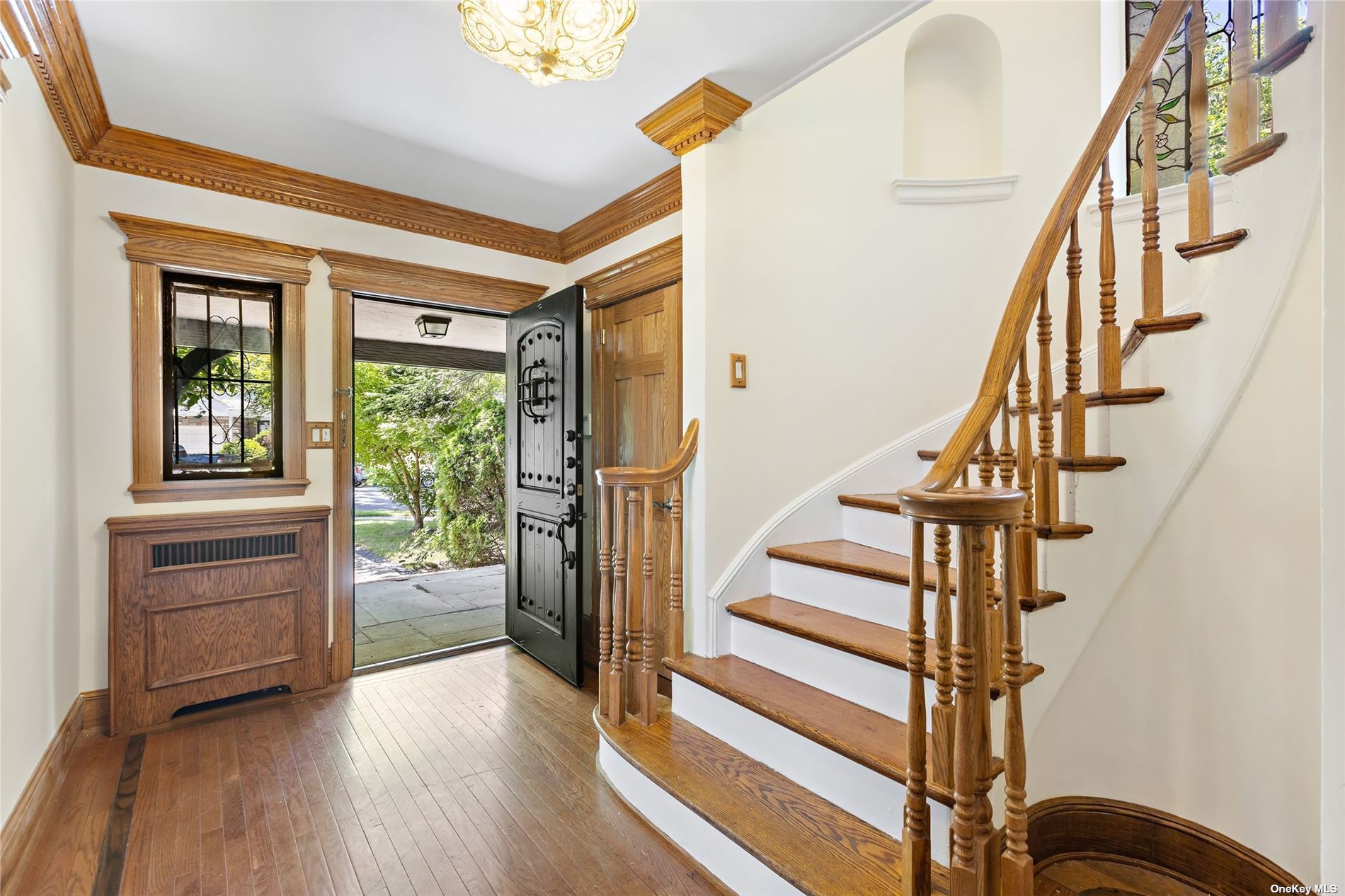 85-23 Edgerton Boulevard Queens, NY 11432 - Photo 4 of 36 a view of entryway with wooden floor and stairs