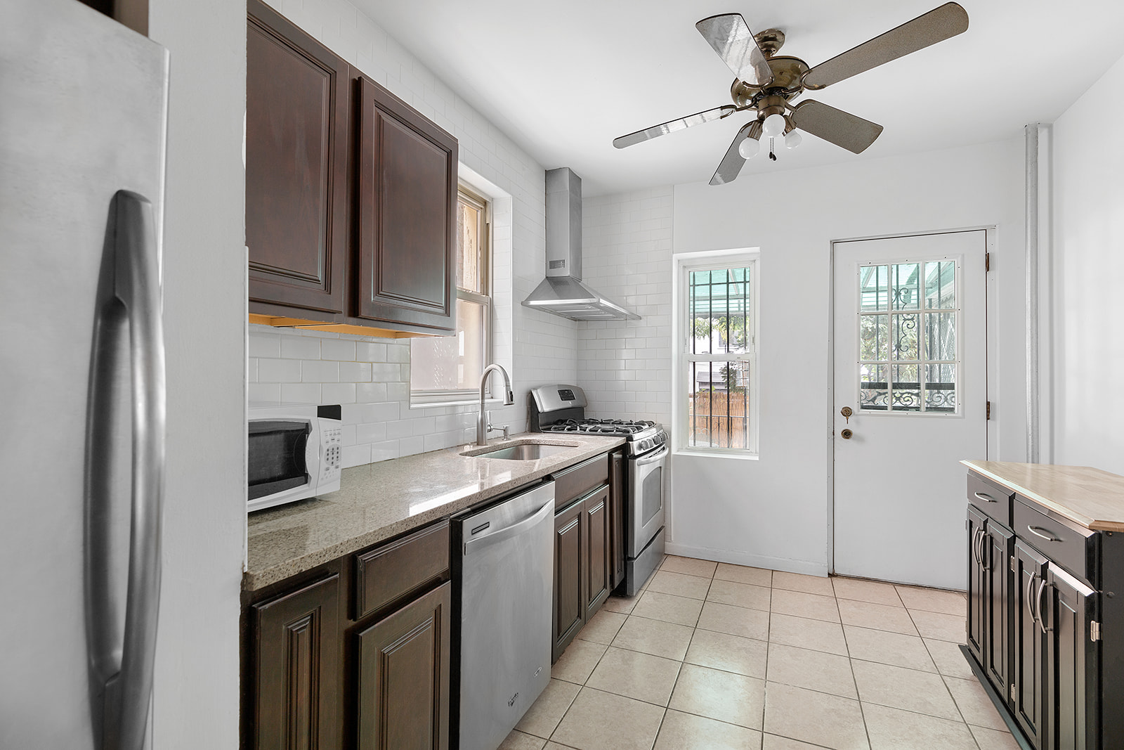 165 Fenimore Street Brooklyn, NY 11225 - Photo 4 of 13 a kitchen with a sink stove and refrigerator