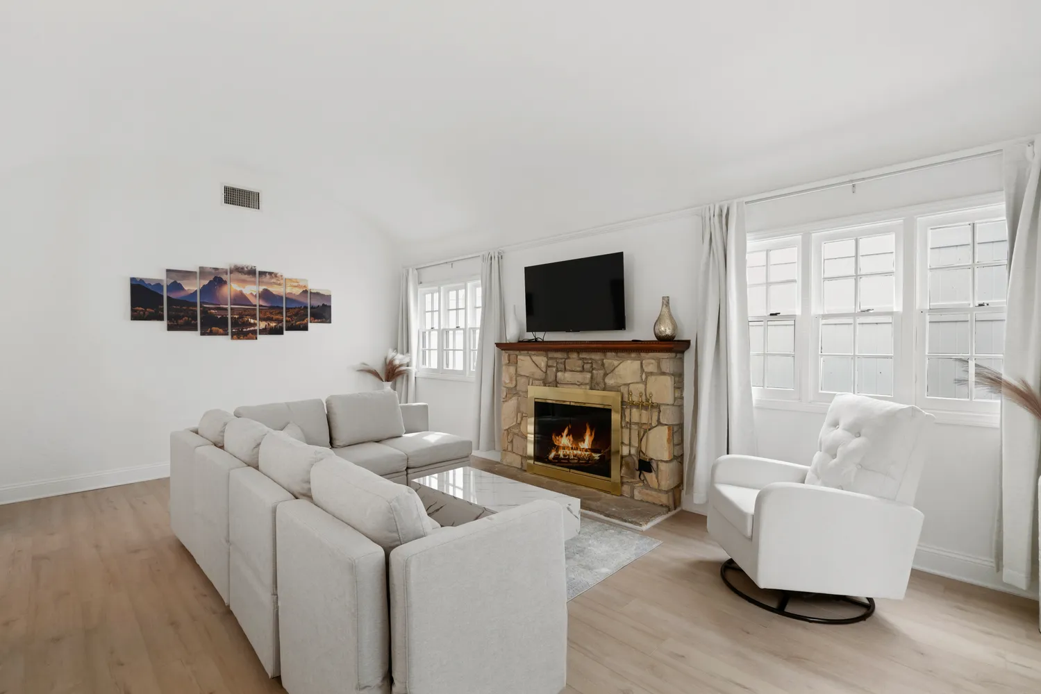 a living room with furniture and a fireplace