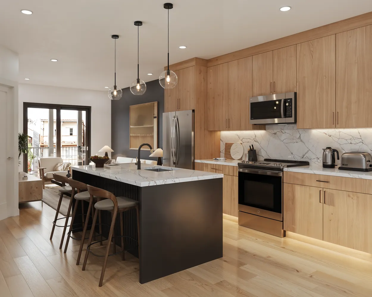 a kitchen with stainless steel appliances granite countertop a sink a stove a refrigerator and island