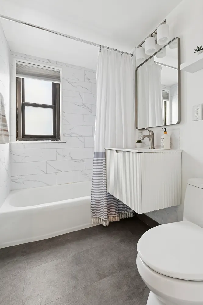 a bathroom with a sink a toilet and bathtub