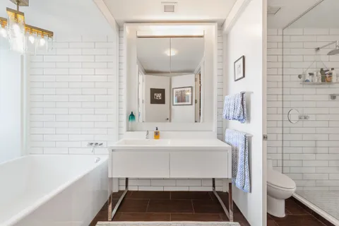 a bathroom with a sink a toilet and bathtub