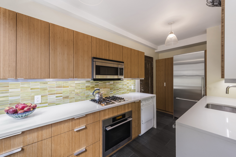170 2nd Avenue, Unit 5E Manhattan, NY 10003 - Photo 4 of 10 a kitchen with a sink cabinets and stainless steel appliances