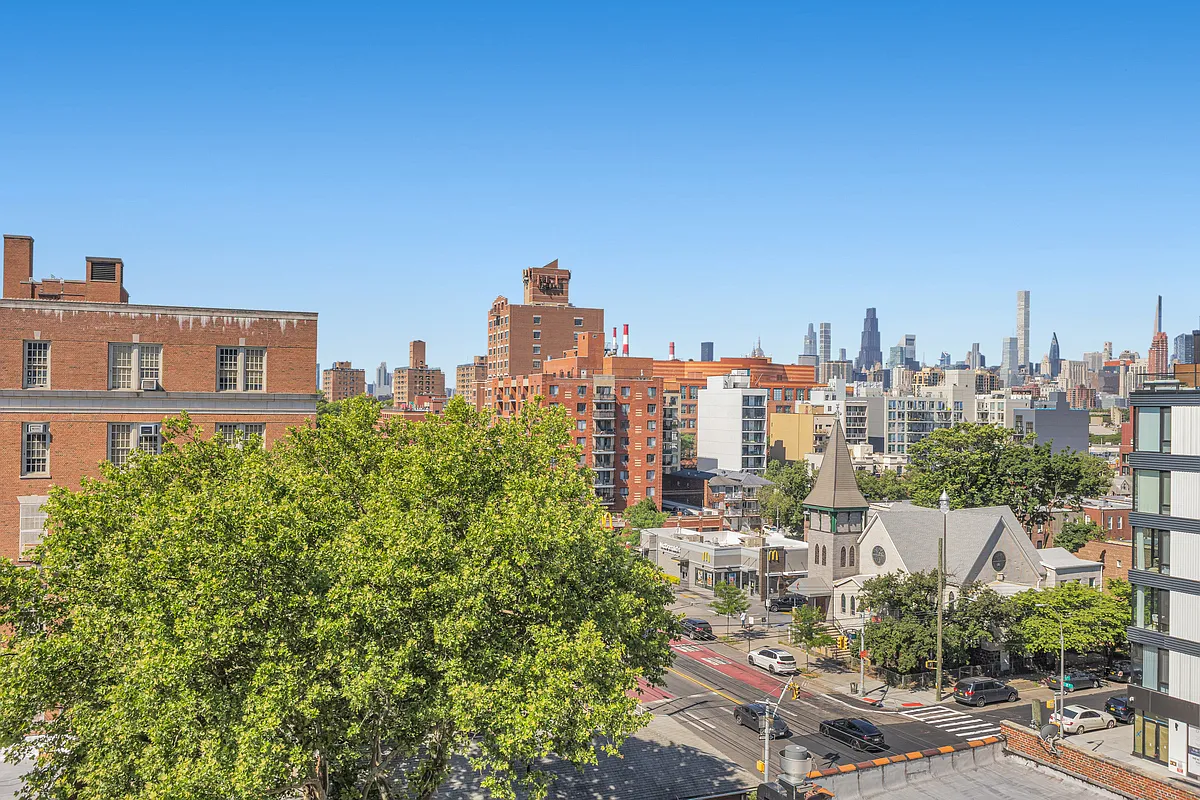 21-10 31st Avenue, Unit 6R Queens, NY 11106 - Photo 13 of 17 a view of a city with tall buildings