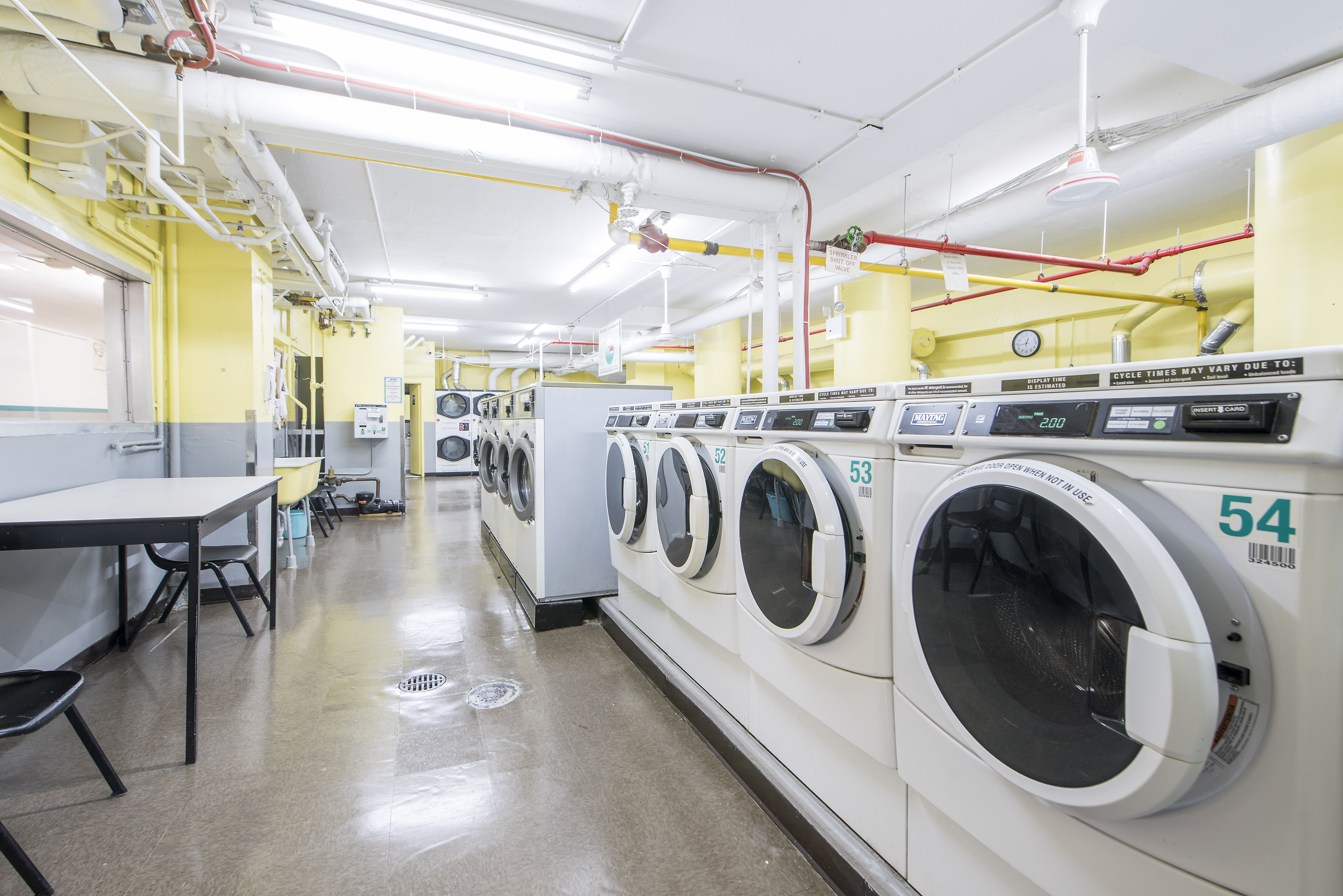 70-25 Yellowstone Boulevard, Unit 11D Queens, NY 11375 - Photo 22 of 25 a utility room with dryer and washer
