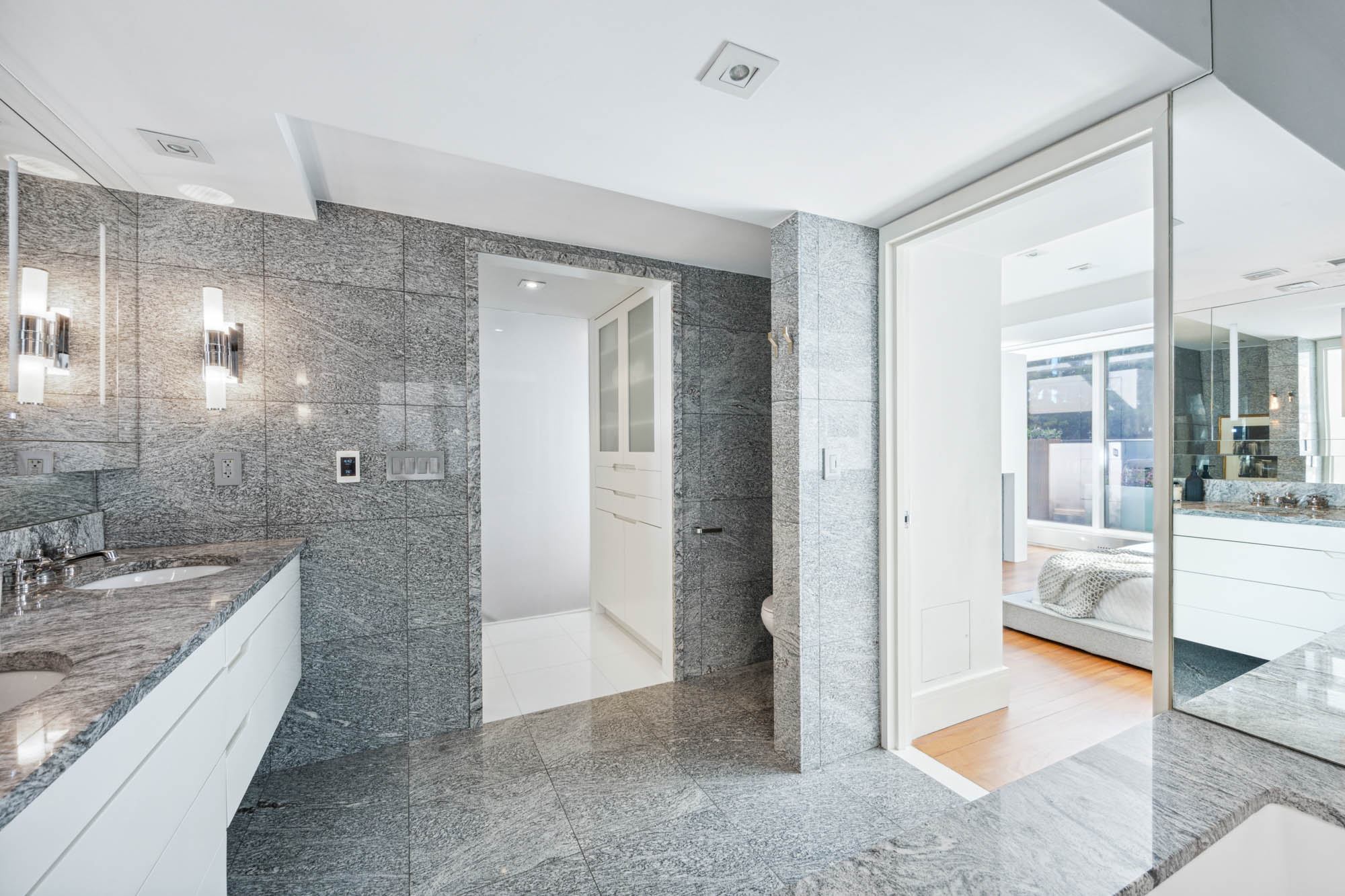 73 Worth Street, Unit PHA Manhattan, NY 10013 - Photo 13 of 20 a bathroom with a granite countertop sink mirror and shower