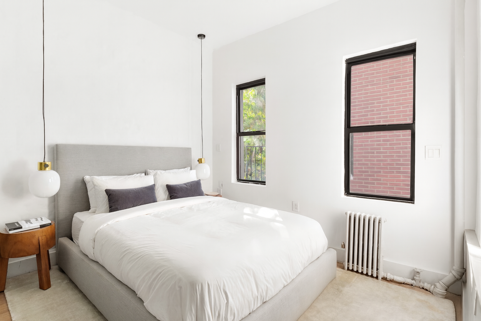 110 Thompson Street, Unit 6E Manhattan, NY 10012 - Photo 4 of 8 a bedroom with a bed and a window