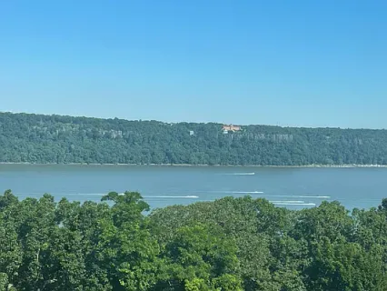 an aerial view of a houses with a yard and lake view