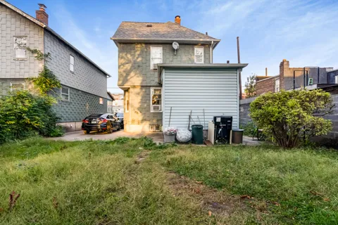 a view of a house with a yard and sitting area
