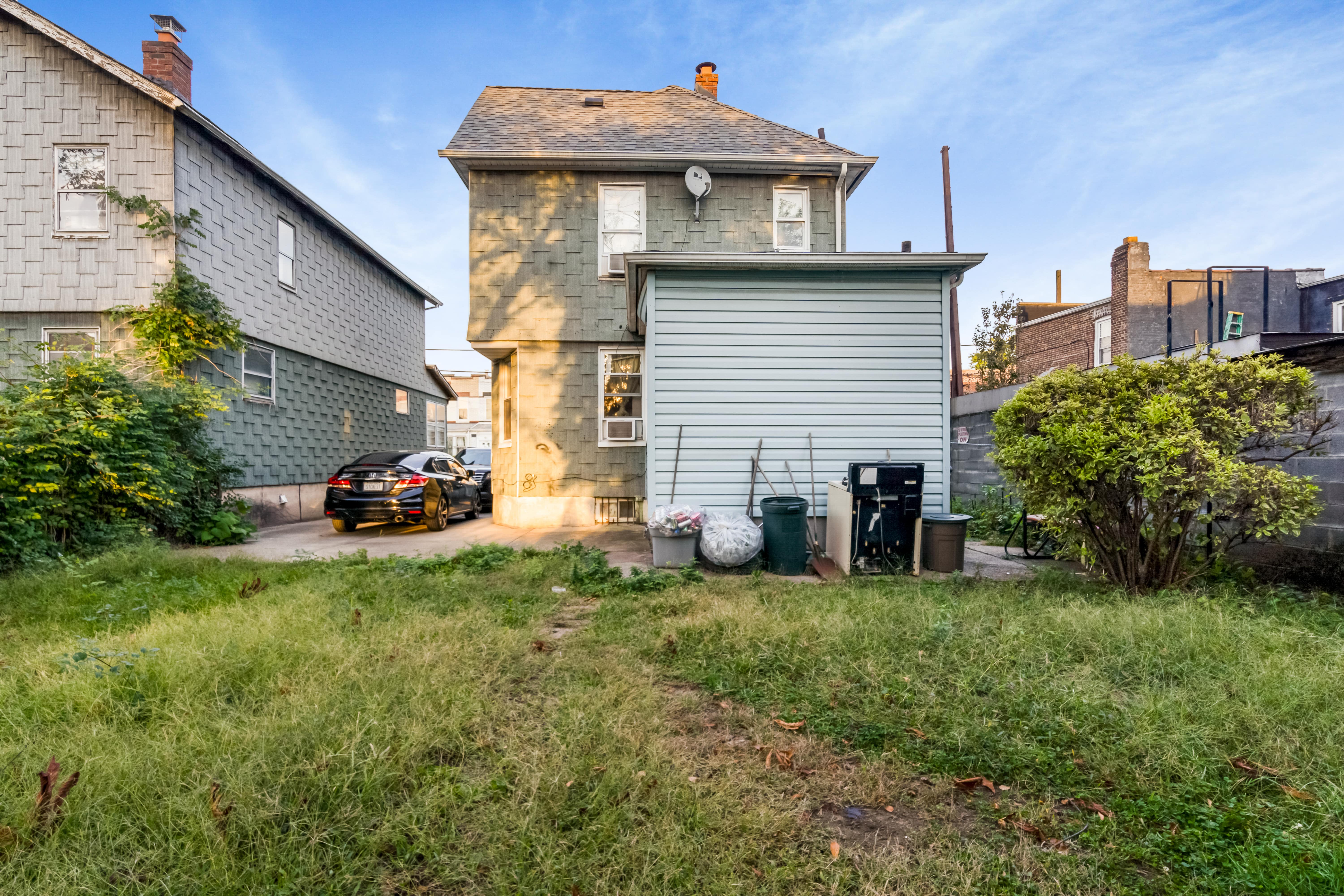 97-30 127th Street Queens, NY 11419 - Photo 15 of 27 a view of a house with a yard and sitting area