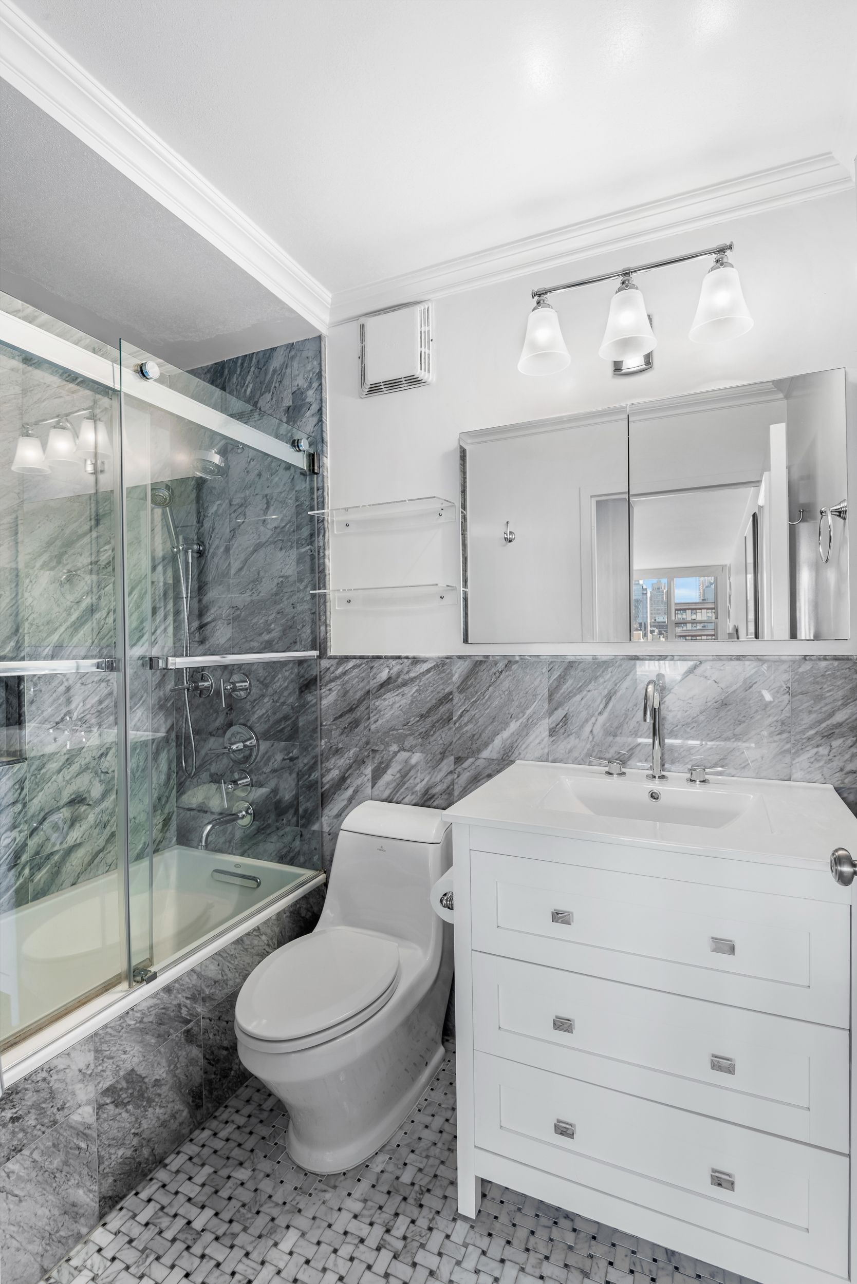 137 East 36th Street, Unit 21F Manhattan, NY 10016 - Photo 11 of 19 a bathroom with a sink a toilet and shower