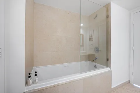a bathroom with a bathtub and a shower