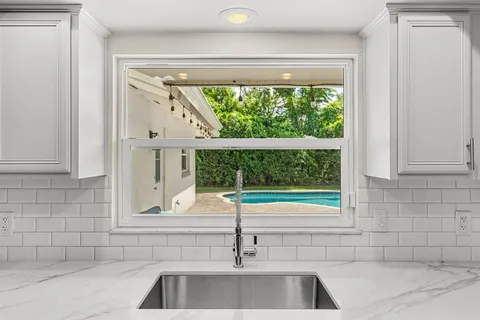 a dining room with furniture wooden floor a chandelier