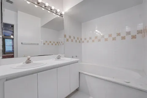 a bathroom with a sink double vanity and a mirror