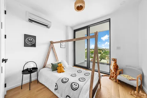 a bedroom with furniture and a window