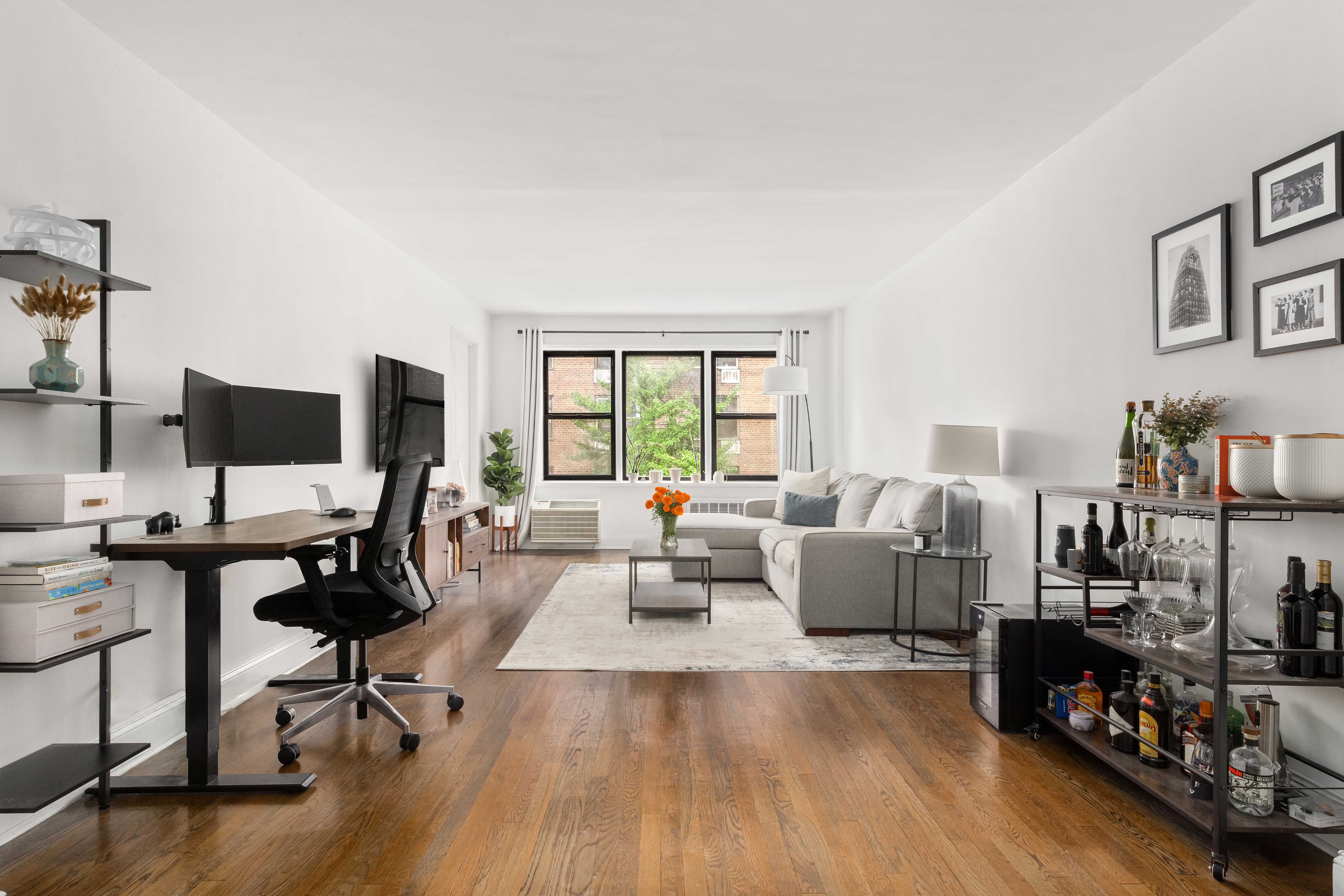 a living room with furniture and a flat screen tv with wooden floor