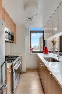 a kitchen with stainless steel appliances granite countertop a sink and a stove
