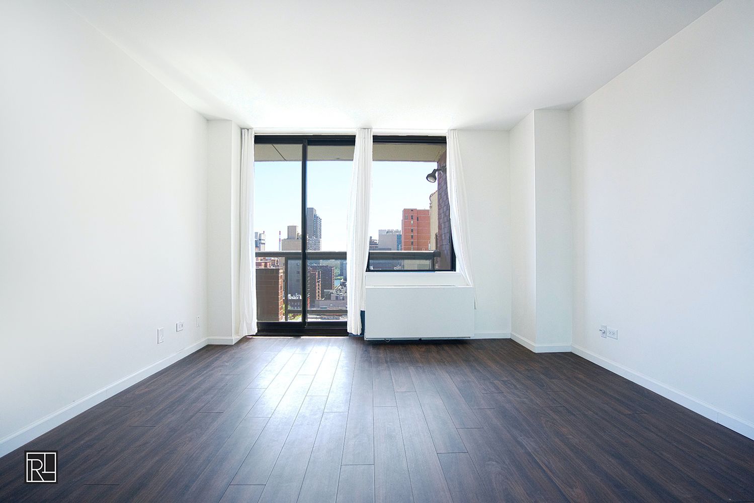 300 East 62nd Street, Unit 1405 Manhattan, NY 10065 - Photo 4 of 10 an empty room with wooden floor and windows