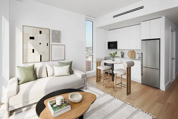 a living room with furniture a wooden floor and a table