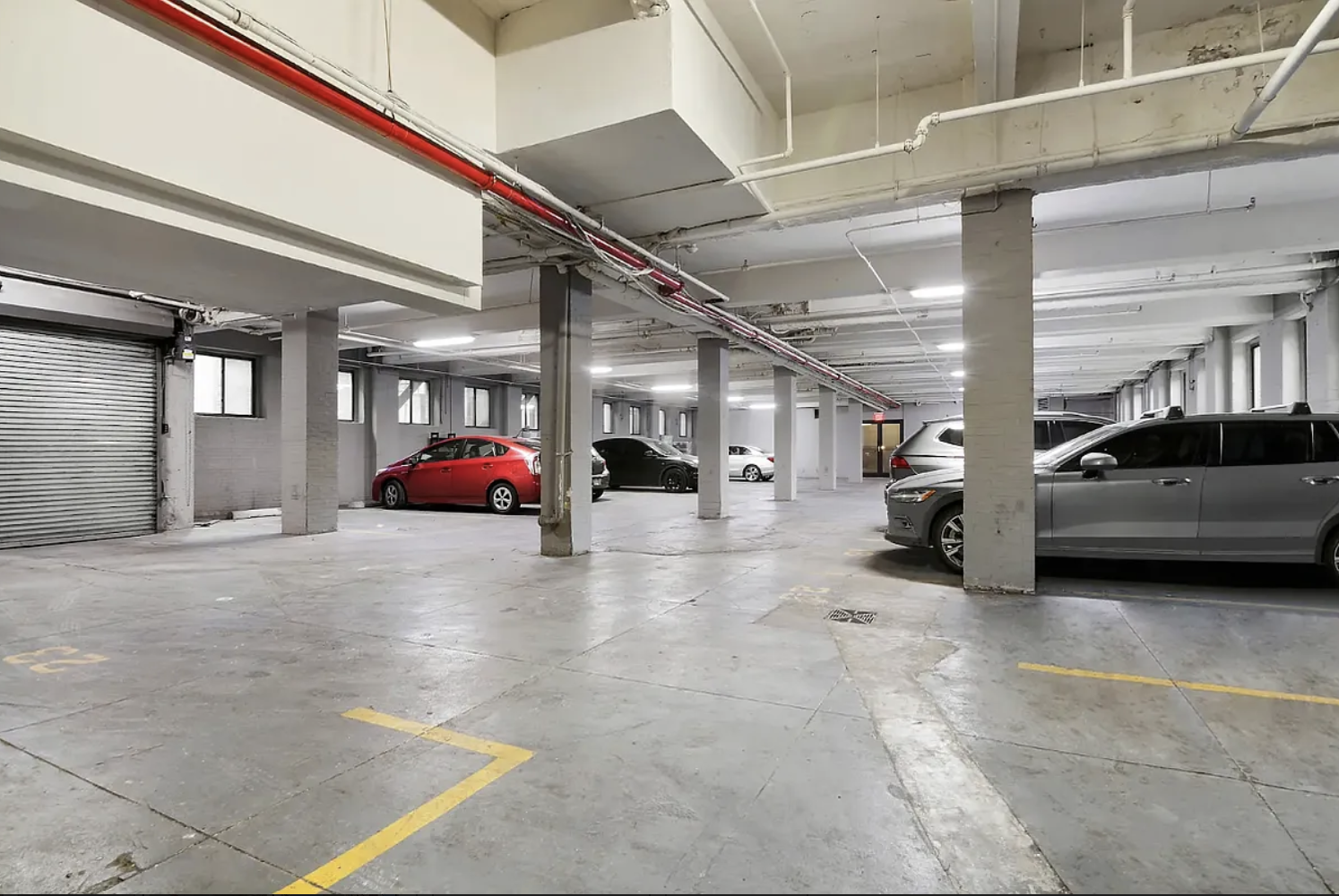 180 Bainbridge Street, Unit 110 Brooklyn, NY 11233 - Photo 20 of 23 a view of parking garage with cars parked