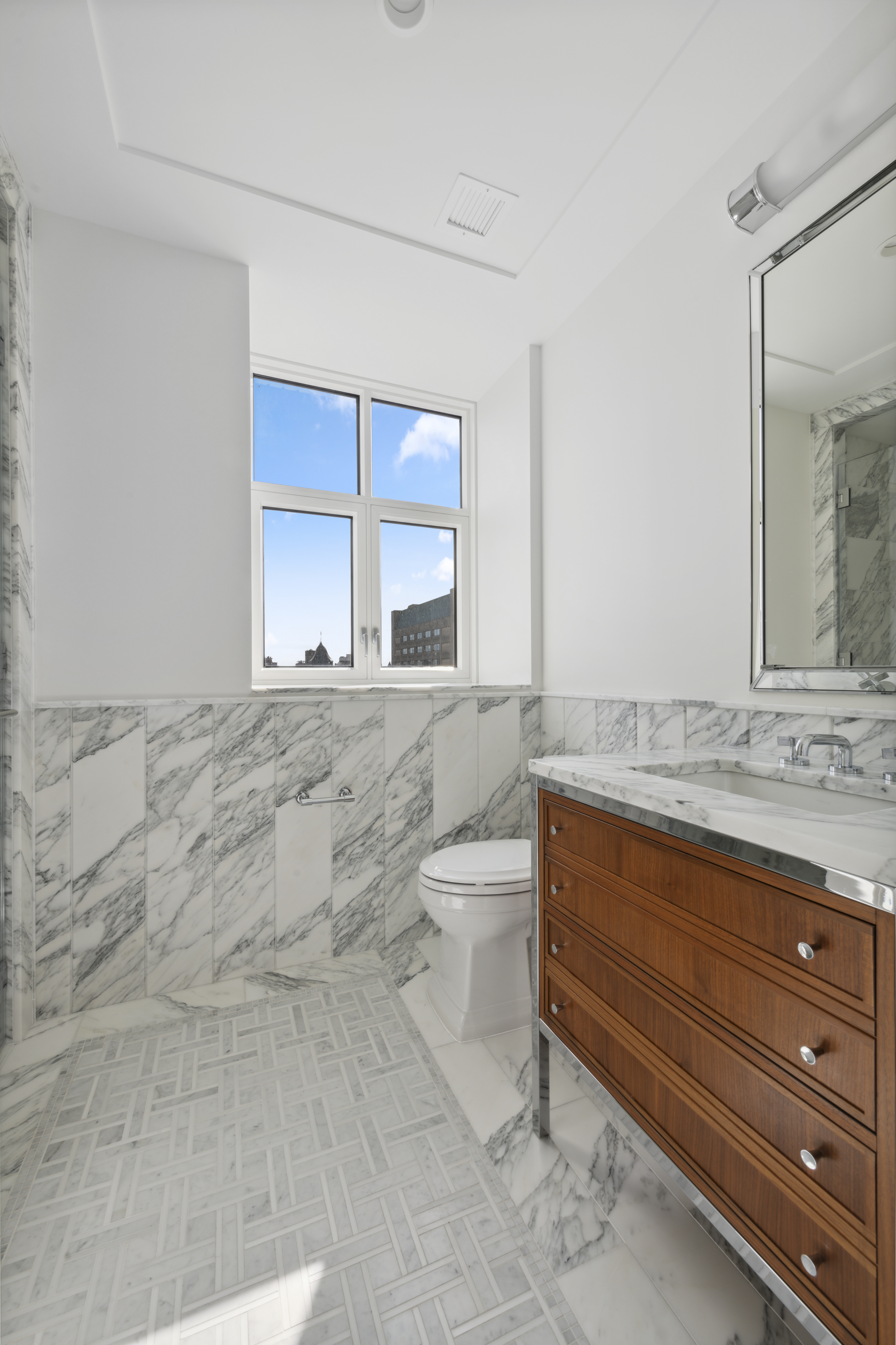 100 Claremont Avenue, Unit 10D Manhattan, NY 10027 - Photo 8 of 11 a bathroom with a granite countertop sink a toilet and mirror