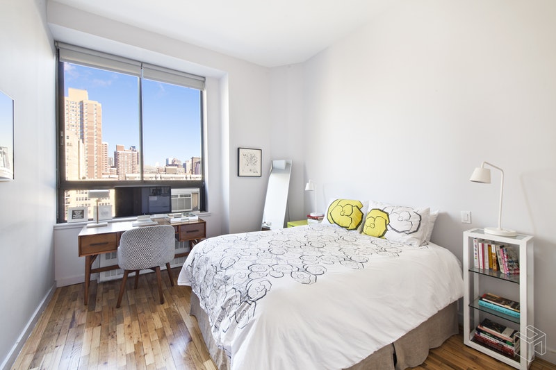 310 East 23rd Street, Unit 11FG Manhattan, NY 10010 - Photo 4 of 9 a bedroom with a bed a table and chair