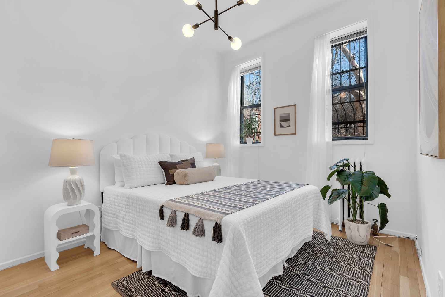 420 6th Avenue, Unit 11 Brooklyn, NY 11215 - Photo 7 of 12 a bedroom with a bed and a potted plant
