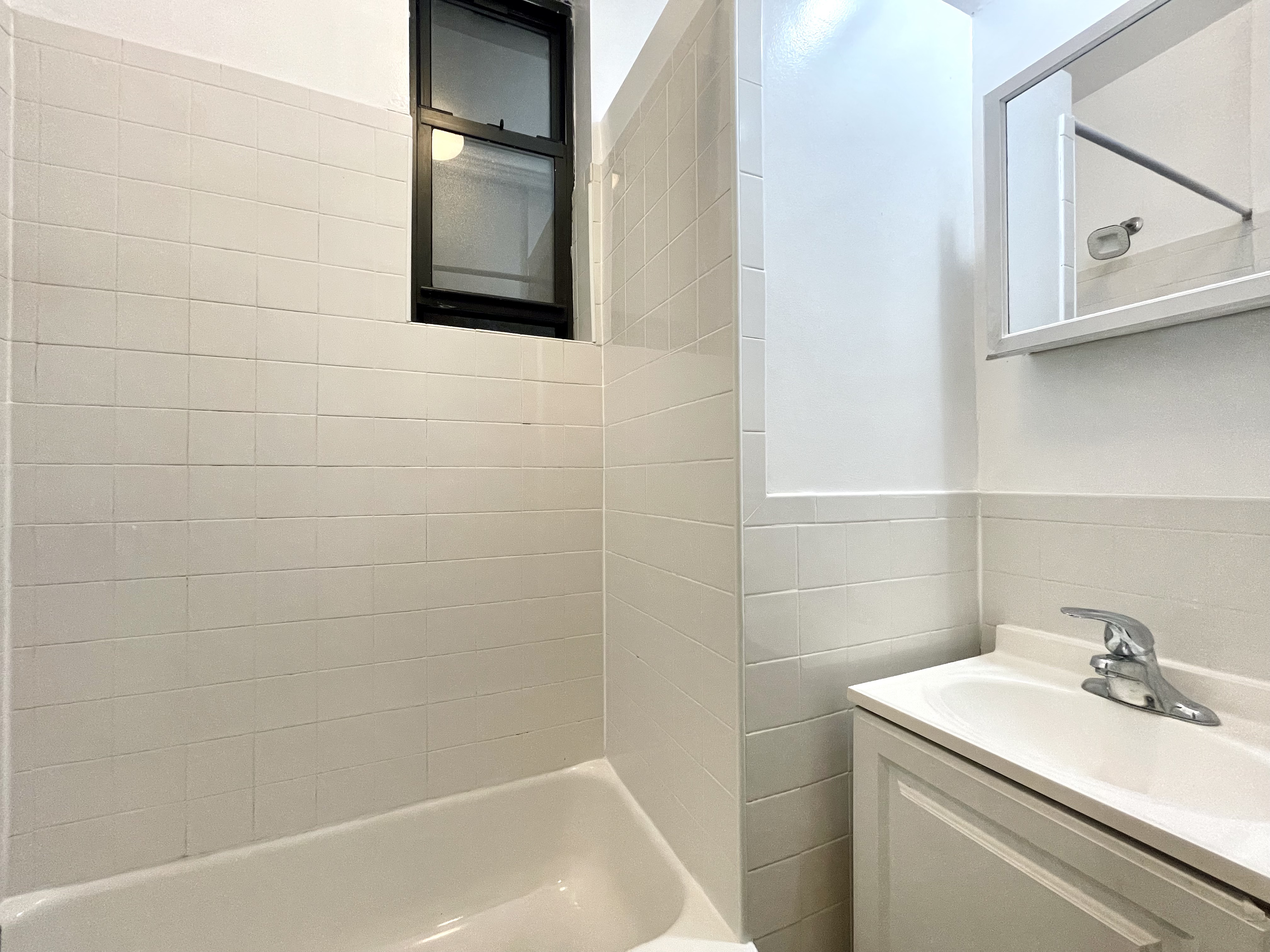 22 St Marks Place, Unit 19 Manhattan, NY 10003 - Photo 6 of 7 a bathroom with a sink and a bathtub