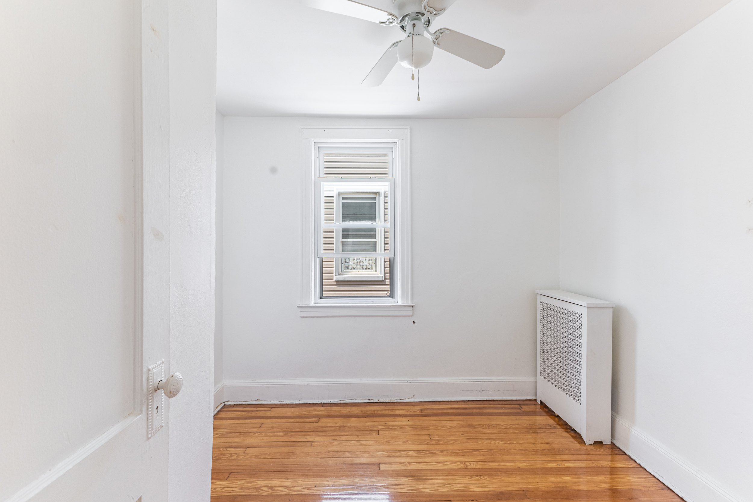 69-29 67th Place Queens, NY 11385 - Photo 16 of 24 a view of an empty room with a window