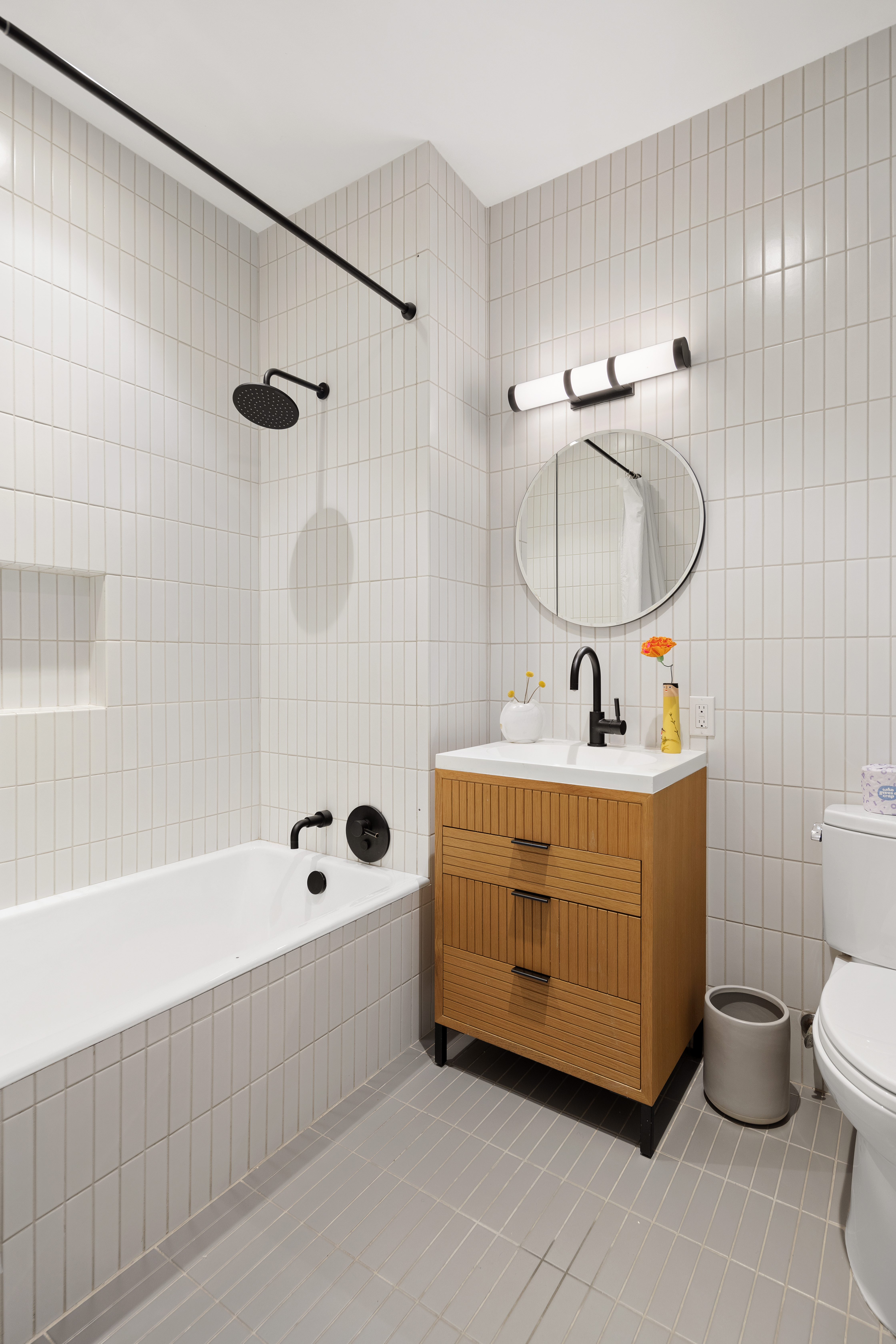 111 Montgomery Street, Unit 1C Brooklyn, NY 11225 - Photo 6 of 15 a bathroom with a sink mirror bathtub and toilet