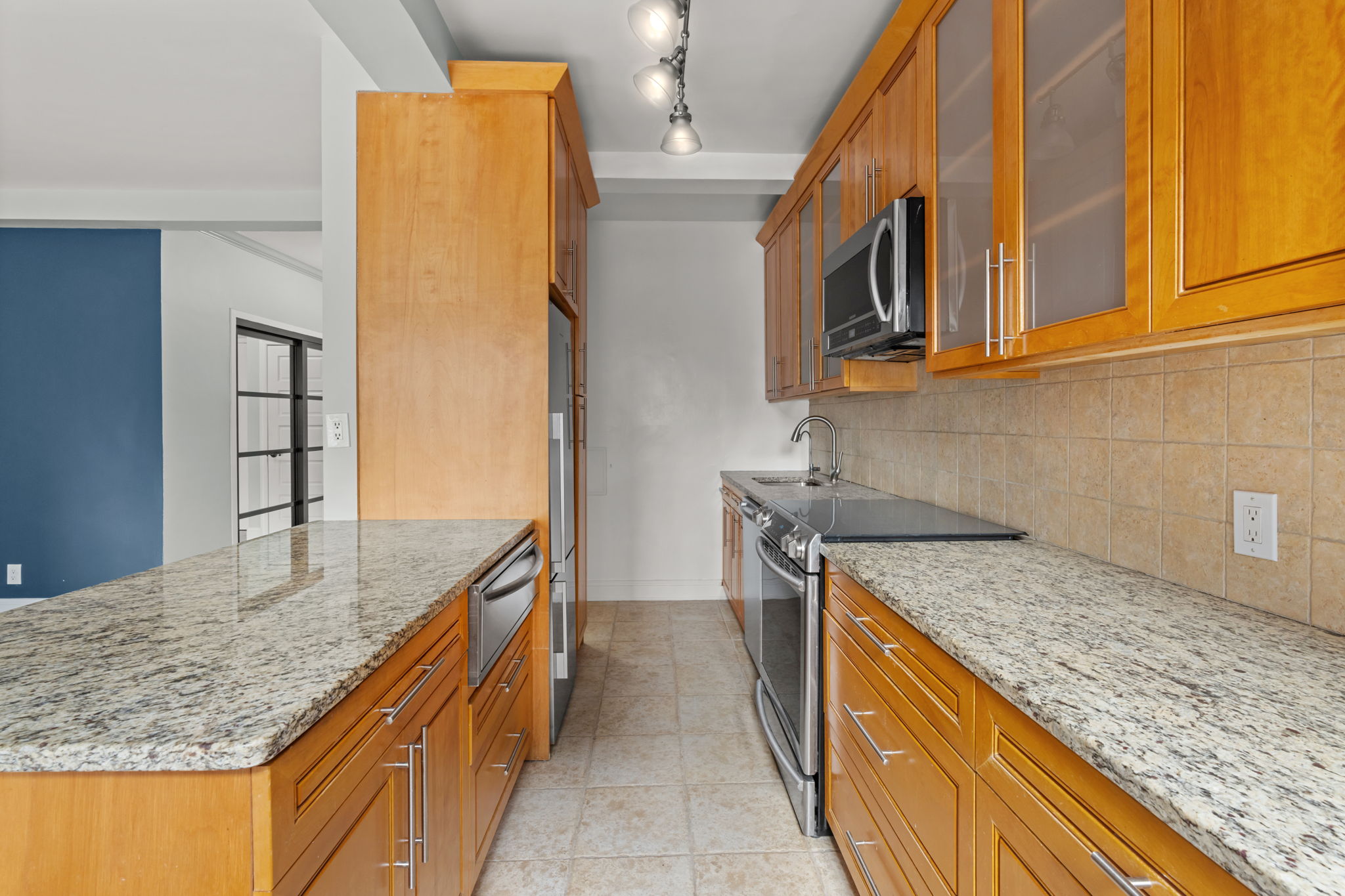 2 Tudor City Place, Unit 6JOS Manhattan, NY 10017 - Photo 5 of 16 a kitchen with stainless steel appliances granite countertop a sink and a refrigerator