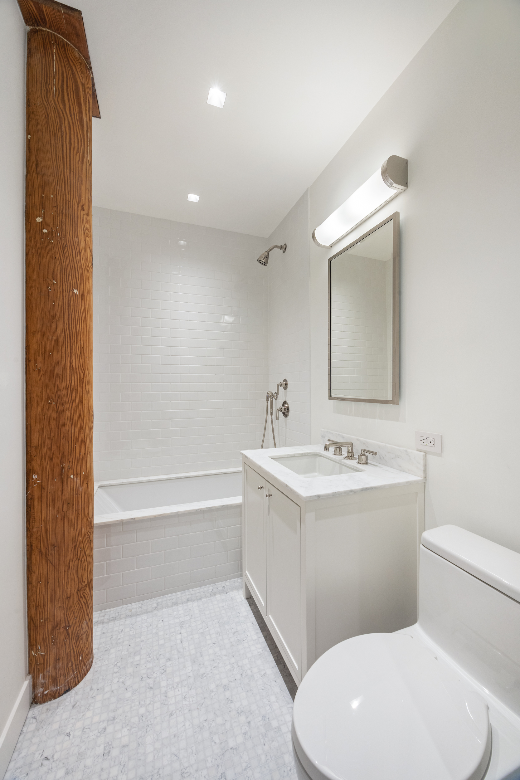 243 West Broadway, Unit 3 Manhattan, NY 10013 - Photo 17 of 25 a bathroom with a toilet a sink and mirror