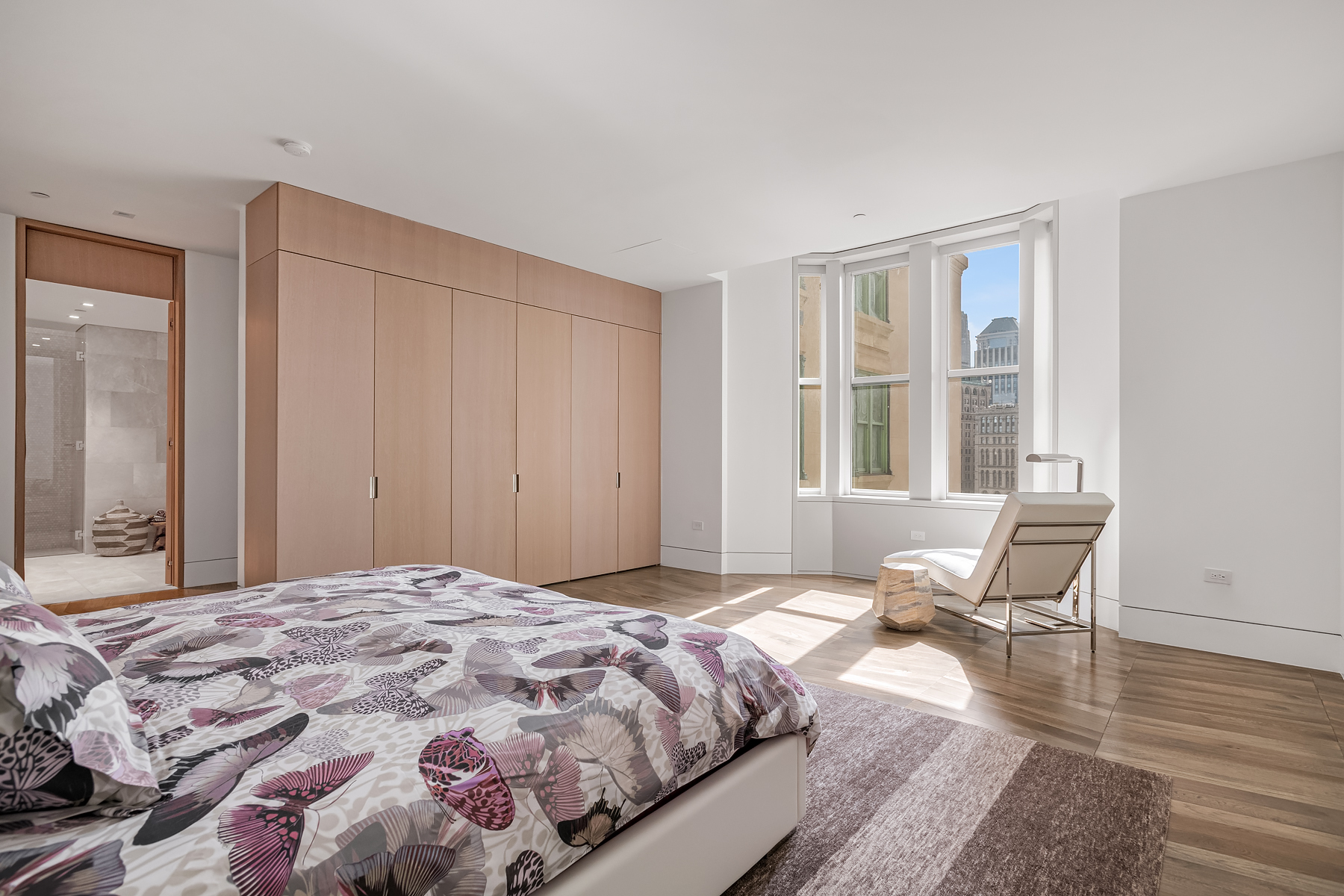 49 Chambers Street, Unit 15B Manhattan, NY 10007 - Photo 4 of 20 a bedroom with a bed and wooden floor