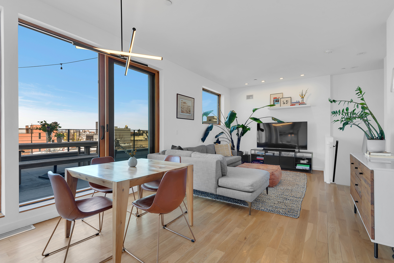 267 Evergreen Avenue, Unit PH Brooklyn, NY 11221 - Photo 2 of 19 a living room with fireplace furniture and a wooden floor