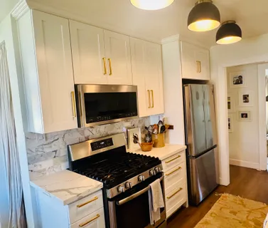 a kitchen with stainless steel appliances a refrigerator stove and microwave