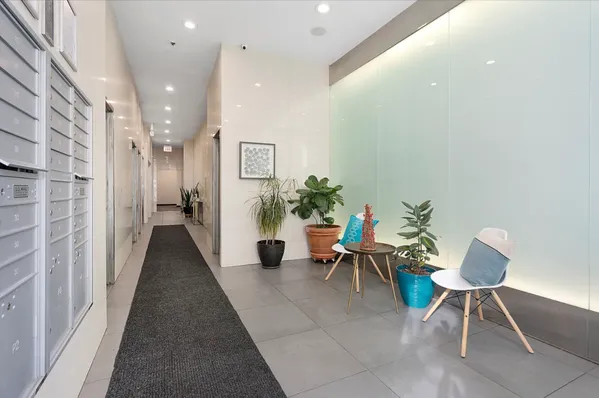 a hallway with furniture and a potted plant