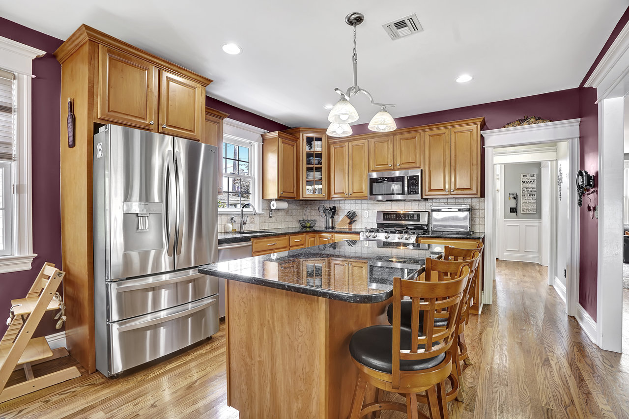 266 Feronia Way Rutherford, NJ 07070 - Photo 13 of 41 a kitchen with stainless steel appliances granite countertop a refrigerator a sink dishwasher a stove and a dining table with wooden floor