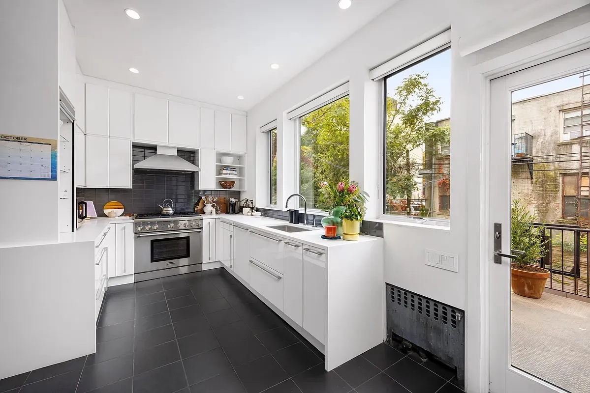 a kitchen with white cabinets and white appliances