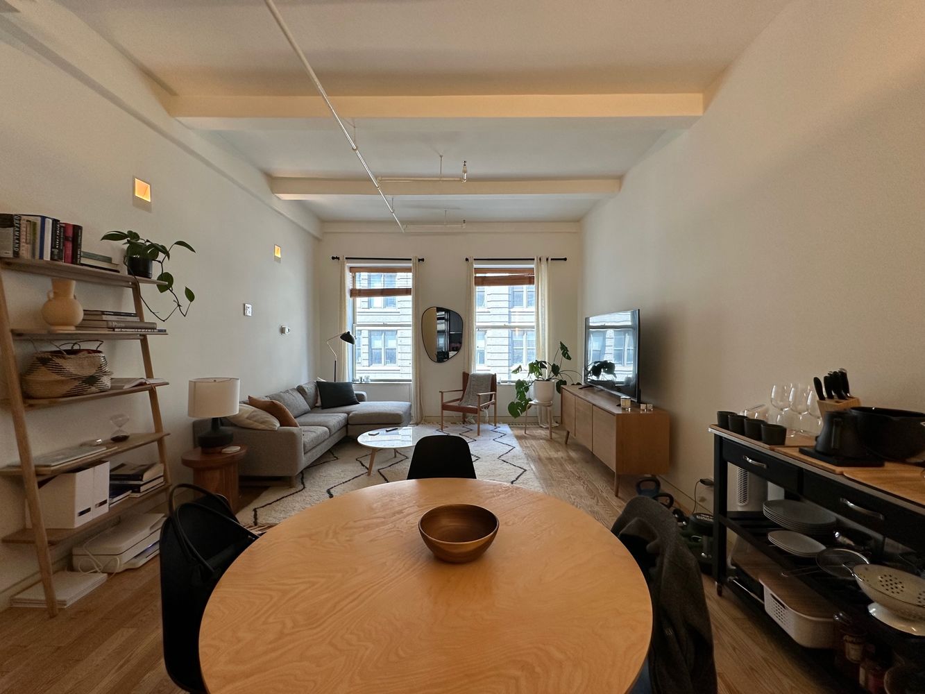 16 West 19th Street, Unit 8B Manhattan, NY 10011 - Photo 2 of 19 a living room with furniture a flat screen tv and a window