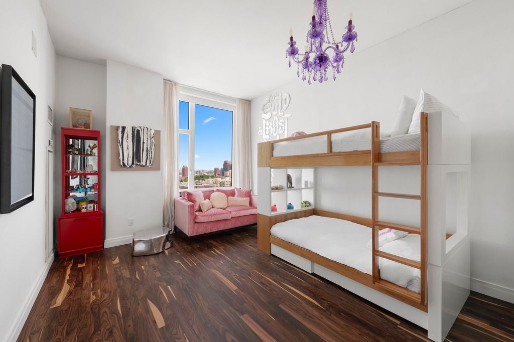 a bedroom with furniture and wooden floor
