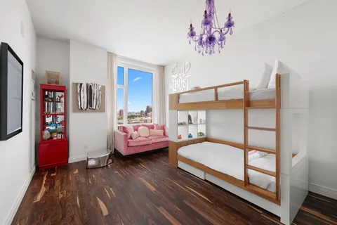 a bedroom with furniture and wooden floor