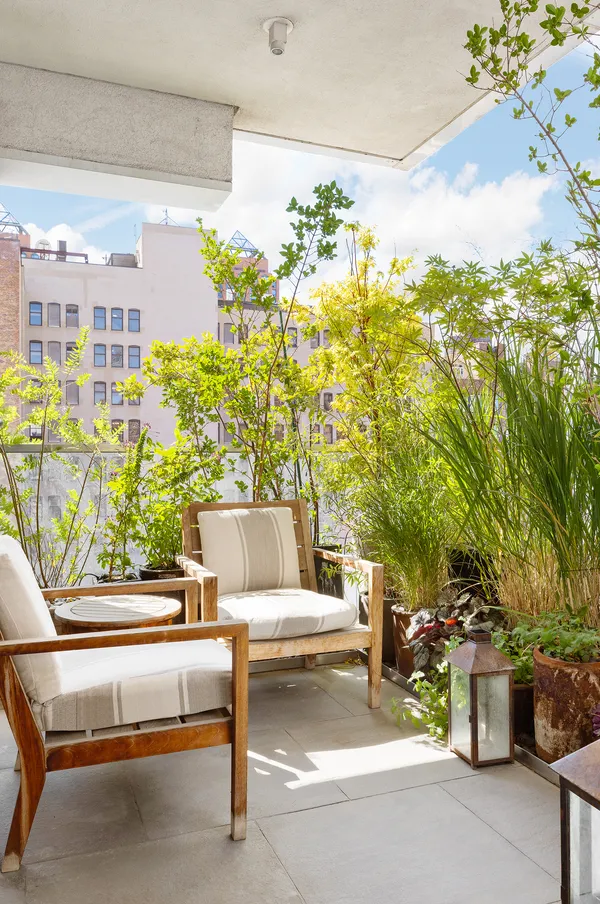 a view of a patio with couches and potted plants
