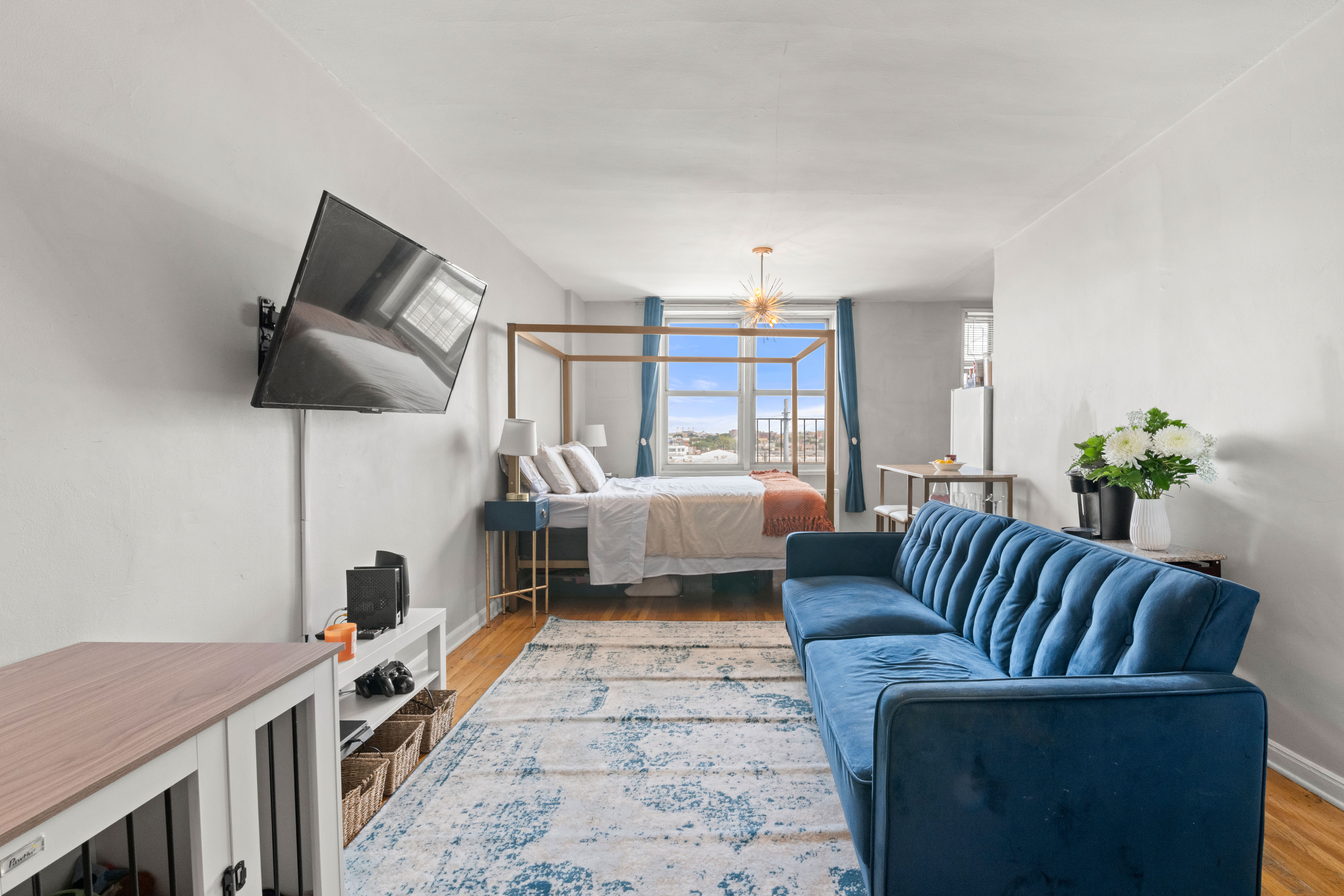 46-01 39th Avenue, Unit 509 Queens, NY 11104 - Photo 2 of 11 a living room with furniture and a flat screen tv