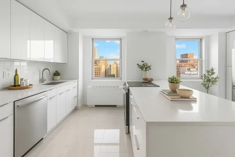 a kitchen with a sink a stove cabinets and counter space